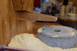 grinding grain into fresh flour at the local market