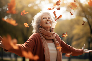Wall Mural - Senior woman with arms outstretched enjoying nature in park. High quality photo