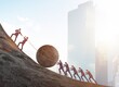 © Elnur - Teamwork example with business people pushing stone to top
