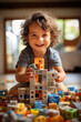 Little kid plays with toy blocks on floor, happy child boy in nursery