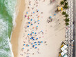 Top down aerial view of people sunbathing and enjoying summer at Copacabana Beach in Rio de Janeiro, Brazil. 