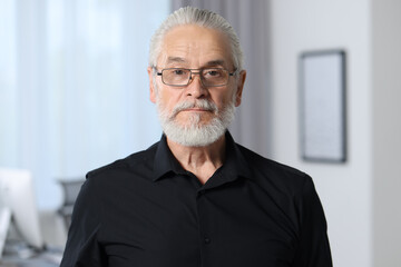 Sticker - Portrait of handsome senior man in black shirt and eyeglasses at home