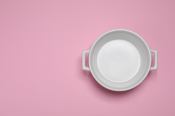 Wall Mural - White empty pot on pink background, top view. Space for text