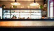 Image of wooden table in front of abstract blurred background of resturant lights
