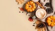 Top view of the cup of coffee, snug plaid, petite pumpkins, leaf, pine cone, cinnamon, and anise on a beige background