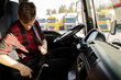 © phoenix021 - Young truck driver putting safety belt on , closeup of man in cabin
