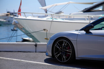 Luxury sports car on the background of yachts.