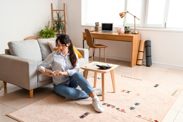 Poster - Young woman planning budget at home