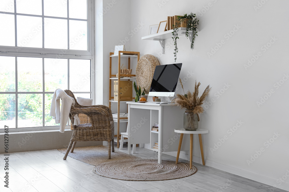 Interior of light office with modern workplace and shelves
