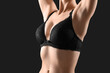 © Pixel-Shot - Young woman in bra on black background