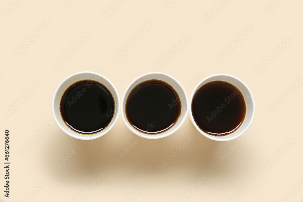 Takeaway paper cups of tasty coffee on light background