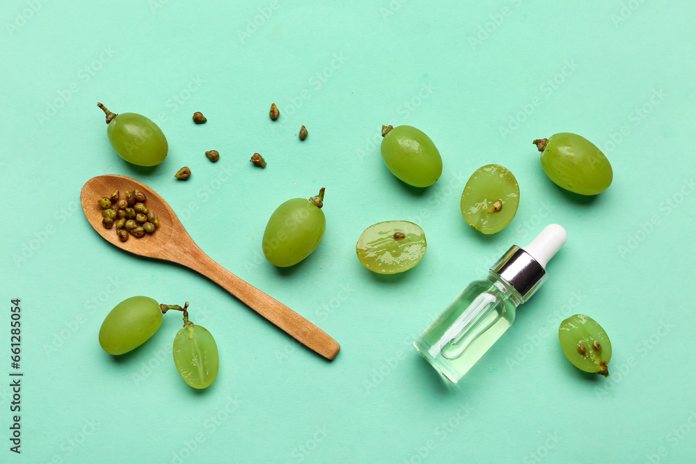 Beautiful composition with ripe white grapes and essential oil on color background