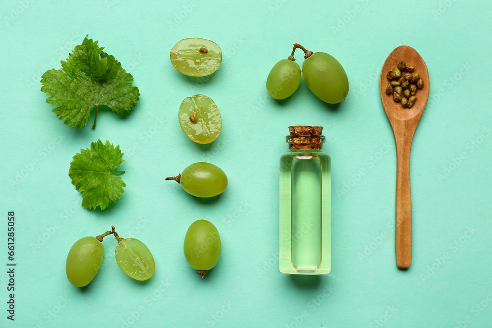 Beautiful composition with ripe white grapes and essential oil on color background