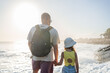 © Julija - Father with child look at the waves on a sunny day
