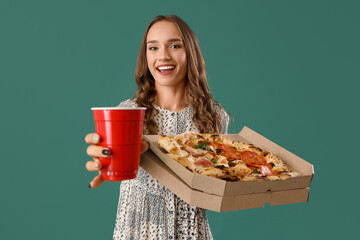 Sticker - Young woman with tasty pizza and beer on green background