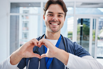 Heart in hands, hospital and portrait of doctor for support, charity and working in clinic for wellness. Healthcare, emoji and happy man with gesture for medical service, consulting and insurance