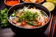 vietnamese pho in a large bowl with chopsticks on side
