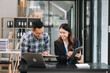 © laddawan - Happy businesspeople while collaborating on a new project in an office. diverse businesspeople using a laptop and tablet