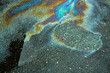 © AleksFil - Colored oil stains close up, the color of the gasoline stain on the pavement road as a texture or background