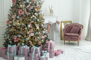 Wall Mural - Beautiful Christmas gifts under fir tree on floor in room.