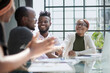 © Katsiaryna - Smiling african american man shaking hands with a business partner at a meeting, greeting, getting to know