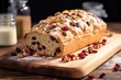 homemade loaf of cranberry walnut bread on a breadboard
