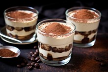 small individual portions of tiramisu in glass cups