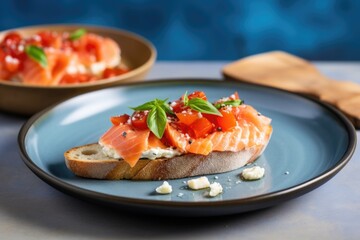 bruschetta with salmon slice on a light blue dish