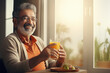 Elderly Indian man holding a glass of fresh juice