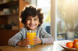 Cute Indian little boy with a glass of milk on the table