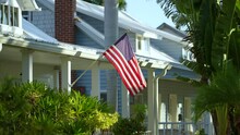 American National Flag Waving In Front Yard Of Florida Private House. Aerial View Of USA Stars And Stripes Spangled Banner As Symbol Of Democracy