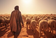 A Man Is Seen Walking In The Desert Accompanied By A Herd Of Sheep. This Image Can Be Used To Depict Concepts Such As Nomadic Lifestyle, Animal Husbandry, Or The Challenges Of Survival In Harsh Enviro