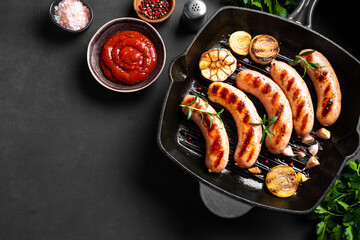 Wall Mural - Grilled sausages with vegetables and rosemary