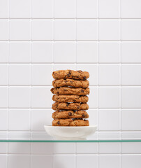 Wall Mural - A delicious healthy cookie with chocolate chunks lies in a small white plate.