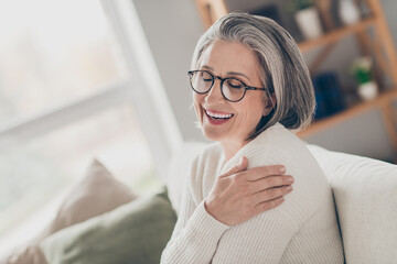 Sticker - Photo of sweet adorable senior lady dressed white cardigan eyewear embracing herself closed eyes indoors house room