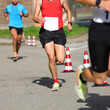 © ChiccoDodiFC - runner running during sports competition on the asphalt road in the city