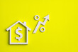 © Luis Echeverri Urrea - Real estate concept in dollars - House icon with arrow on green background