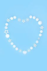 Wall Mural - Christmas heart shape wreath. White snowflakes, stars and balls. Romantic symbol for holiday season on blue background. Festive symbol for greeting card, menu, invitation, logo.