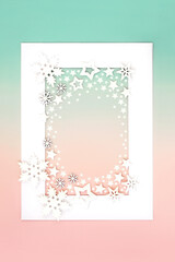 Wall Mural - Fantasy Christmas white snowflake star decorations abstract on white frame on gradient green pink background. Magical North pole theme for holiday season.