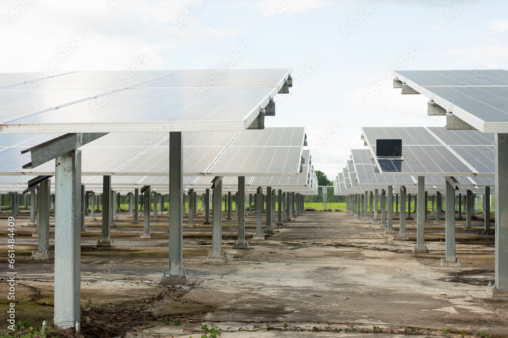 Engineer uses laptop computer to inspect solar panels, solar cell farm ...