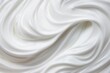 Texture of liquid white cream with soft lines, top view.