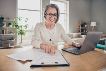 Poster - Photo of dreamy sweet senior lady assistant dressed white cardigan preparing document modern gadget indoors house room