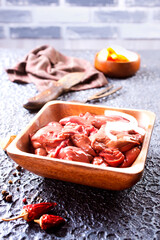 Canvas Print - Raw liver with onion in wooden bowl