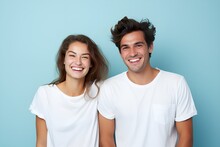 Young Fictional White Couple Smiling. Isolated On A Plain Blue Background. Generative AI.