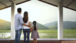 © Raiyah - family standing in front of the window and looking at the nature