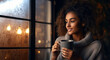 Black woman holding a cup of coffee a winter day. Young girl drinks a hot drink in a cozy house.