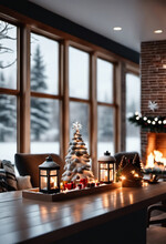 Focus On Tabletop Christmas Decor On Table In Modern American Home Interior, Large Fireplace With Warm Fire And Snow Covered Exterior Viewable Through Large Glass Windows In Background.