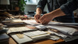 © MP Studio - Businessman hands working in Stacks of paper files for searching information on work desk in office, business report papers.