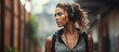 © AkuAku - Sporty woman wearing earphones focusing on workout in the city With copyspace for text