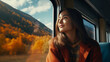 Cinematic and symmetrical beautiful shot of female traveler, travel blogger and inspired adventurer hang out of train window, look at amazing landscape of autumn mountains 